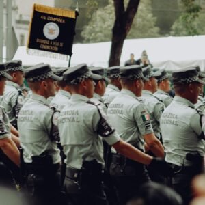 A group of uniformed National Guard soldiers marching in formation during a parade.